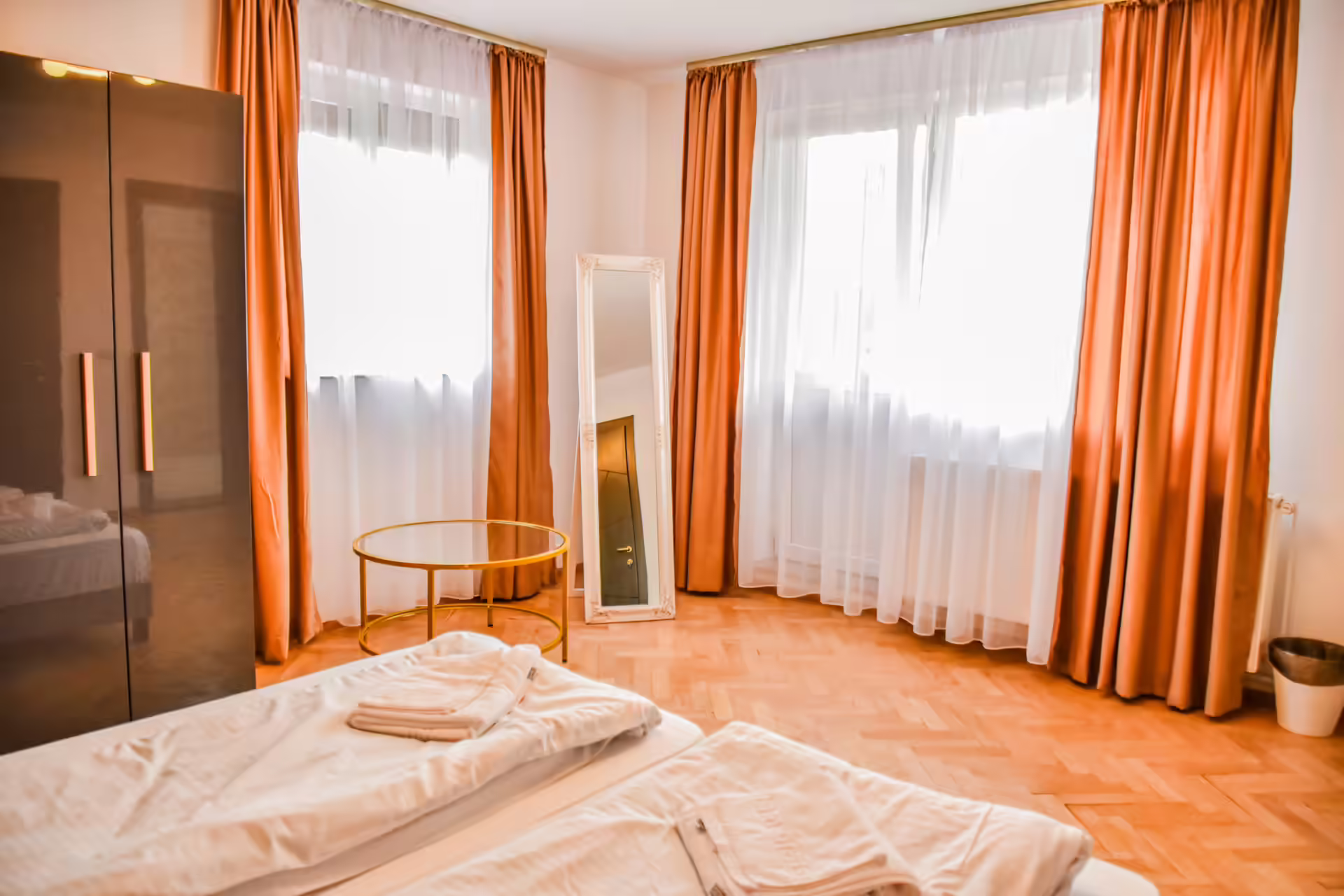 Cameră matrimonială cu draperii portocalii la Random House Cameră matrimonială cu draperii portocalii la Random House