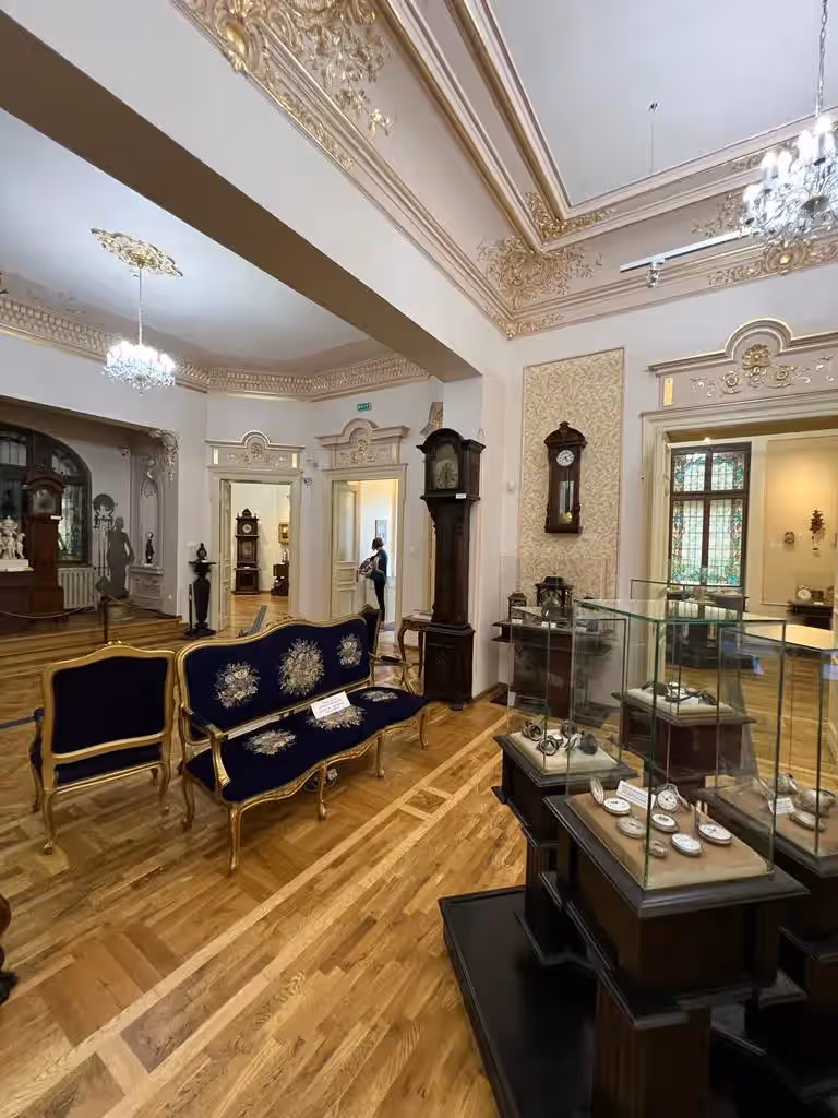Salon cu ceasuri de podea și mobilier de epocă în Muzeul Ceasului